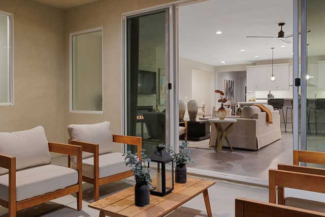outdoor living space at dusk looking into the model home.