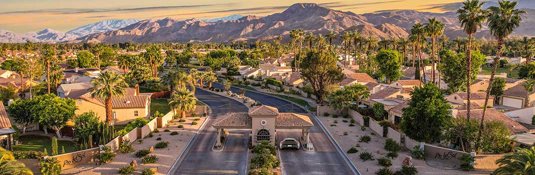 aerial view of entry gates at Rio Del Sol with the sun setting.