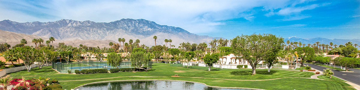 view of community from above the pond towards the mountains.