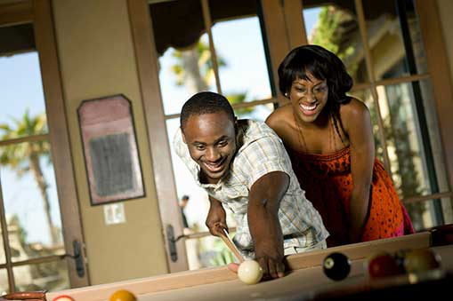 African American couple playing pool